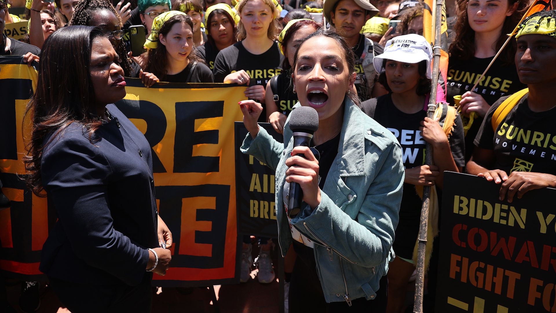 Rep. Cori Bush (D-MO) (L) and Rep. Alexandria Ocasio-Cortez (D-NY) rallying hundreds of young climate activists to demand that U.S. President Joe Biden work to make the Green New Deal into law