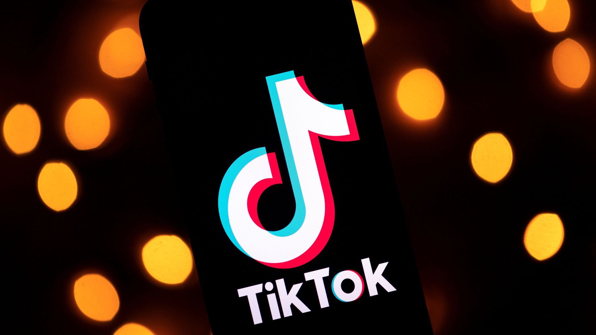 An image of the TikTok logo with orange dots