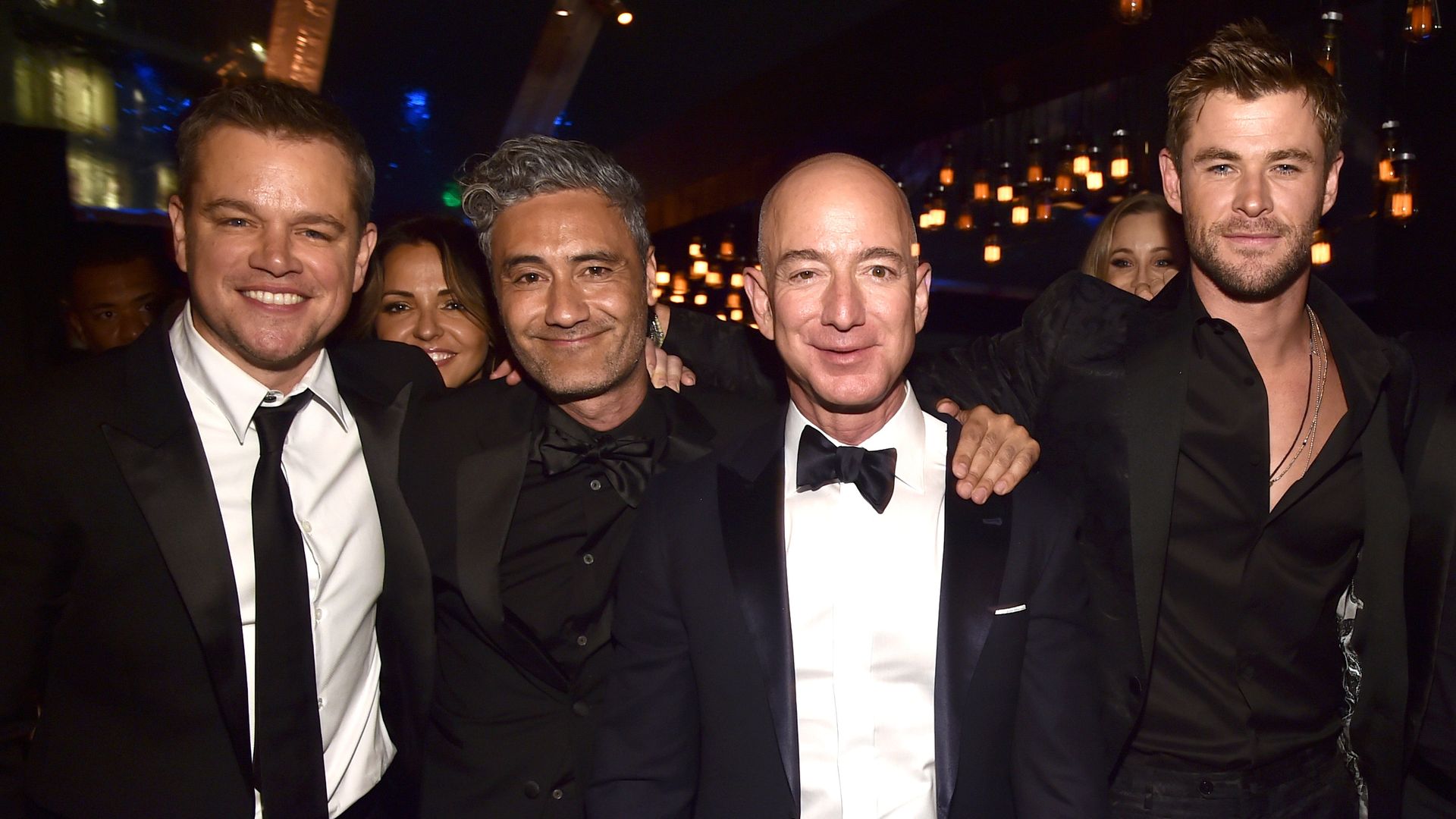 Jeff Bezos surrounded by Matt Damon, Taika Waititi and Chris Hemsworth at a Golden Globes party