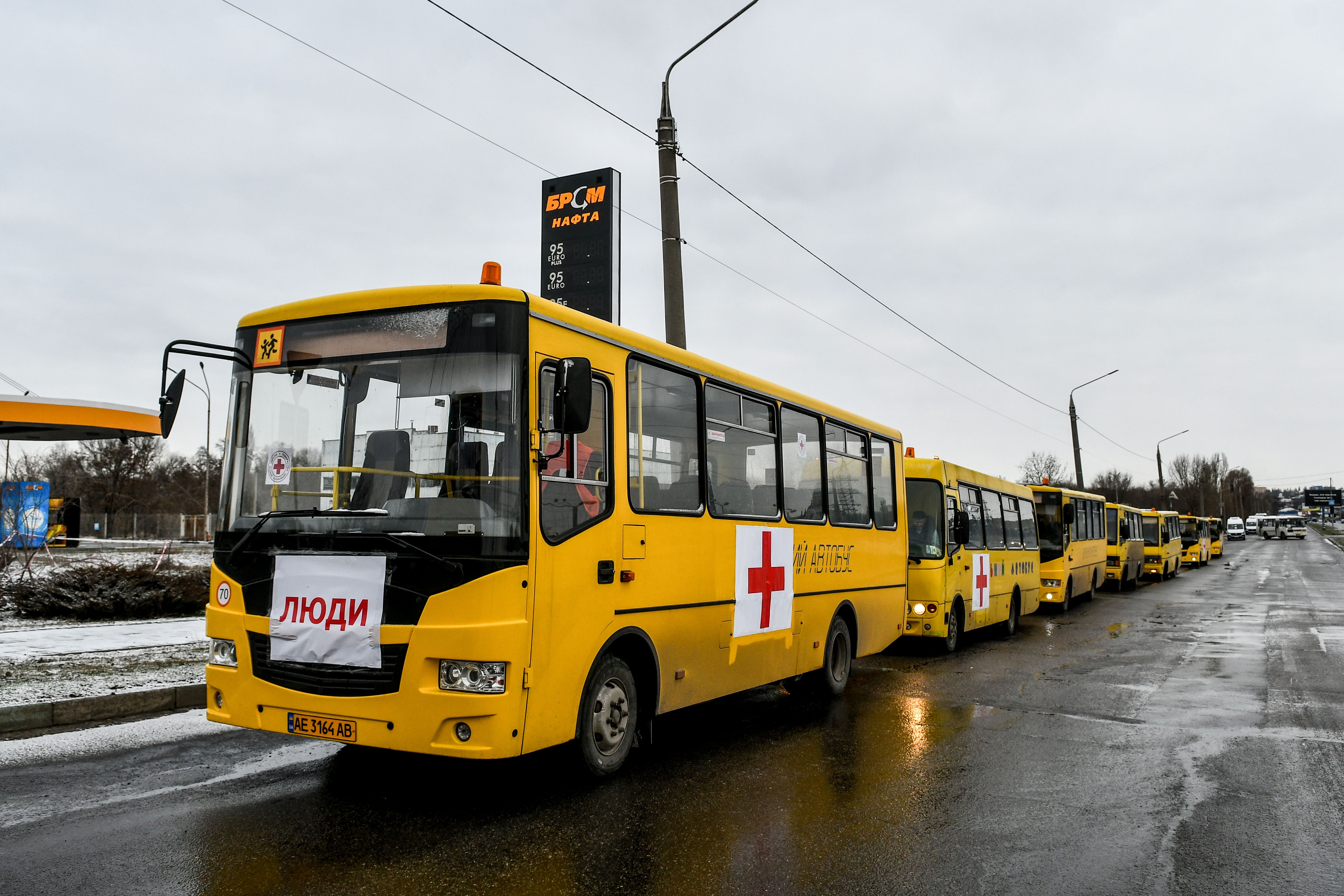 A convoy of buses featuring red crosses is set to take off for besieged Mariupol to deliver humanitarian aid and evacuate people on March 6.
