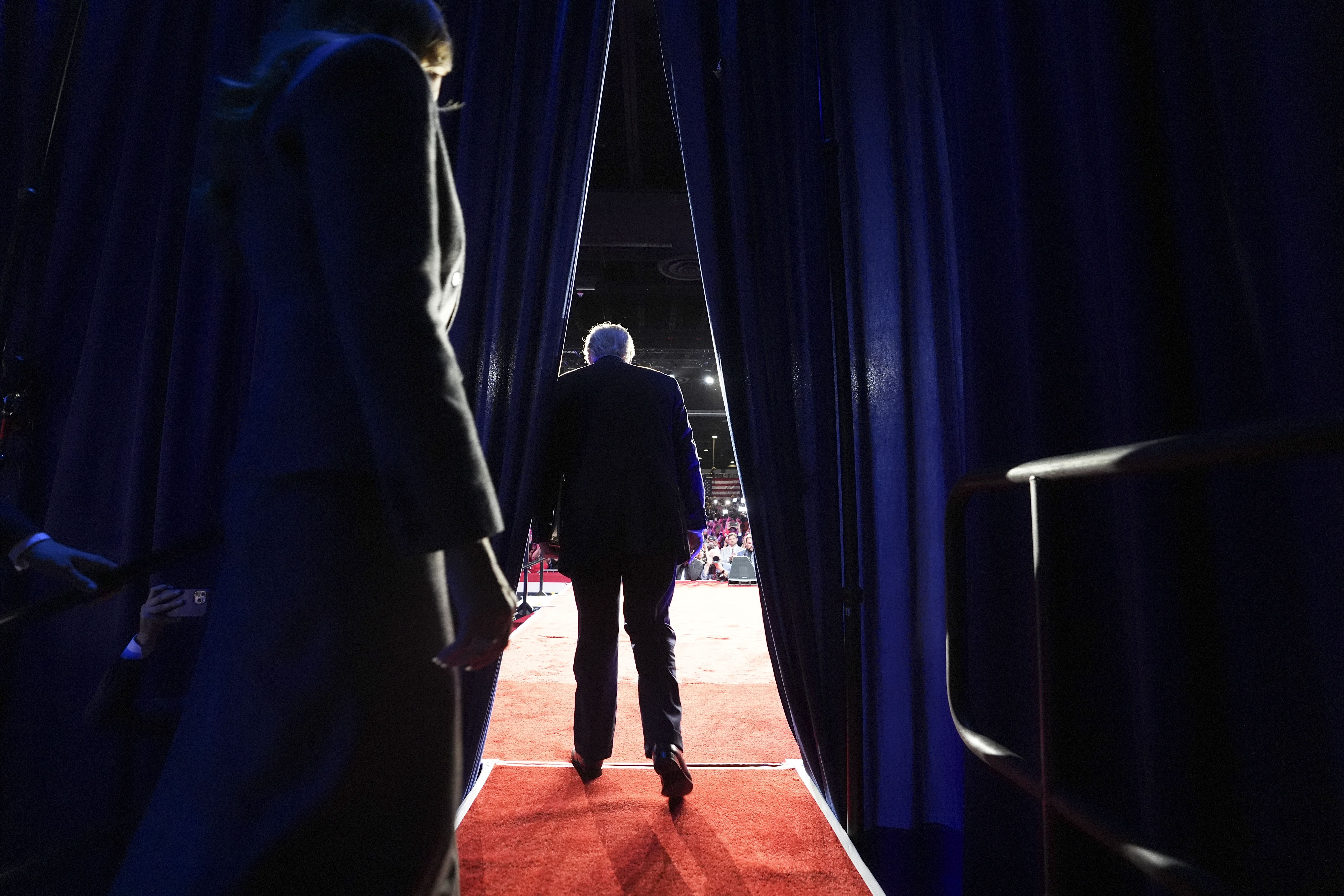 President-elect Trump walks on stage with Melania Trump during his watch party last night in West Palm Beach, Fla.