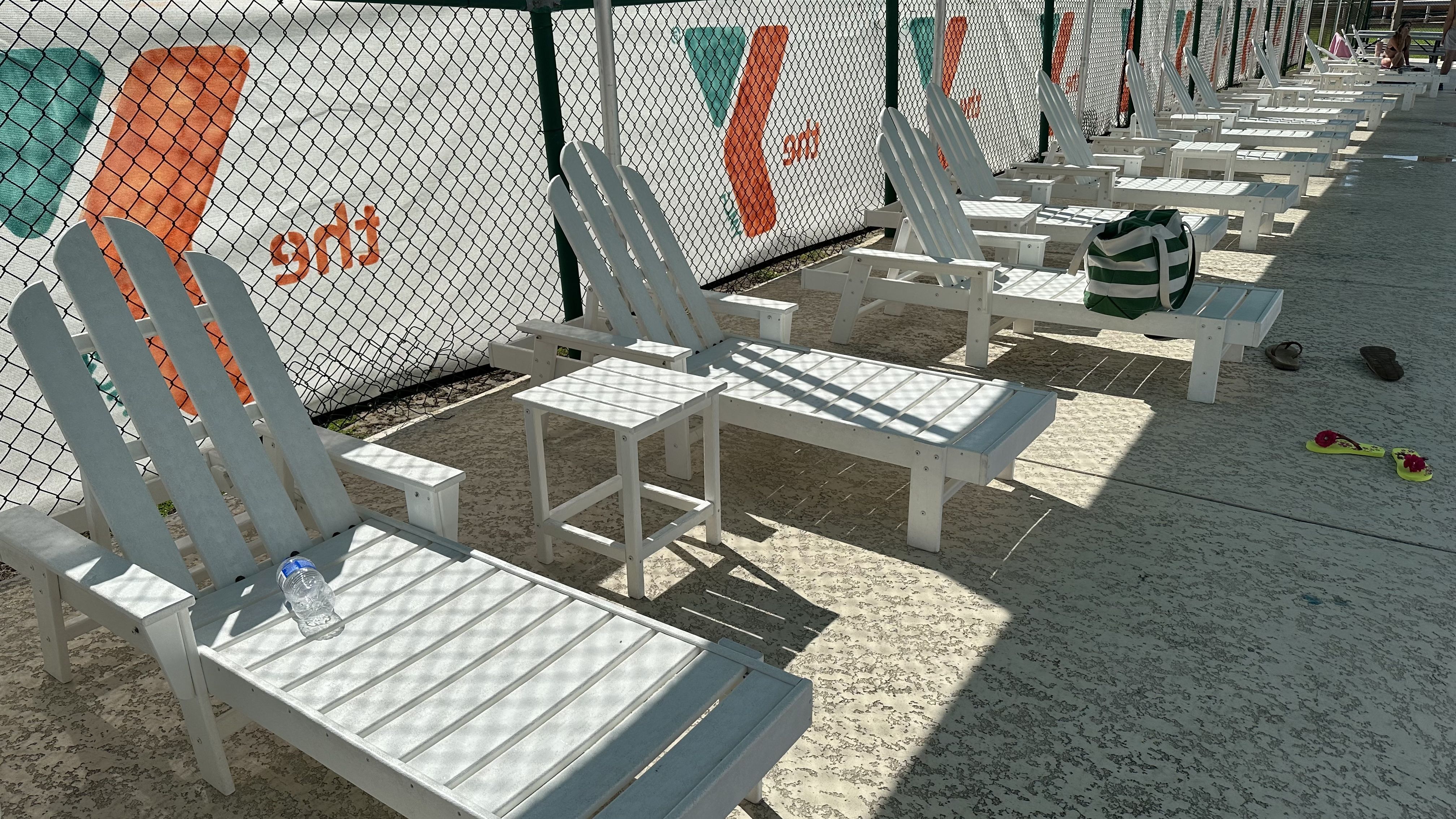 Photo shows white lounge chairs