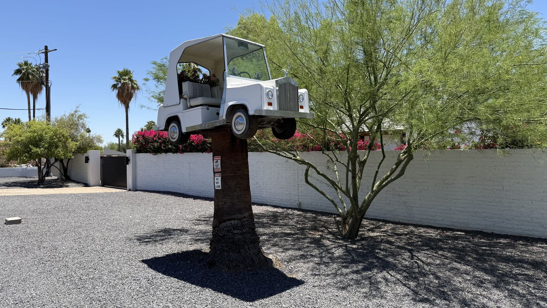 A golf cart mounted atop a metal column.