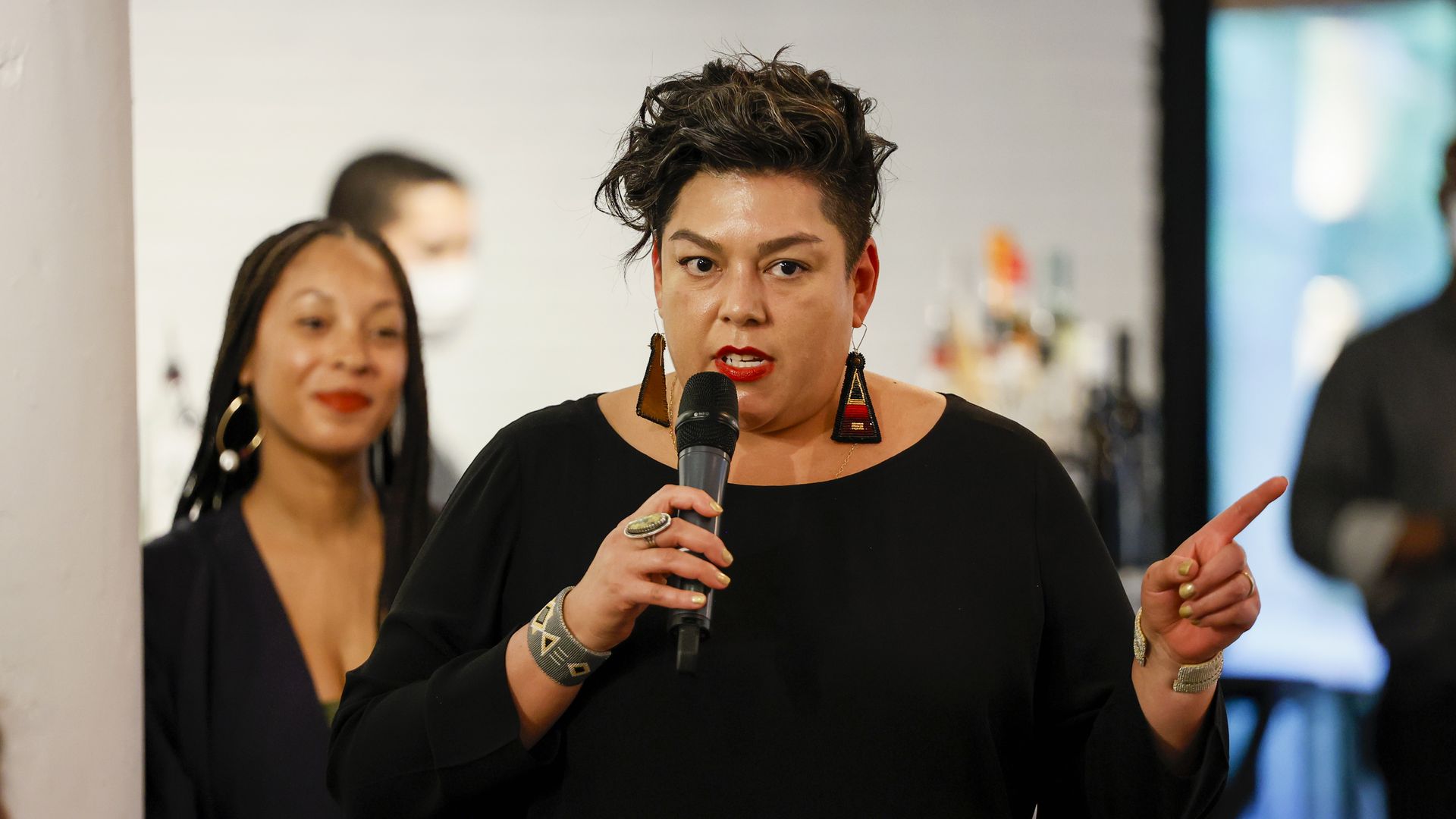 A woman speaking into a microphone. 