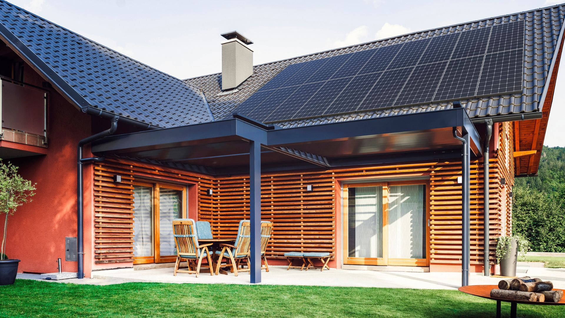 The back porch of a house. There are solar panels on the roof.