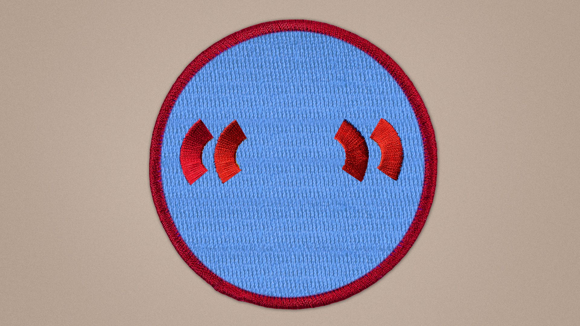 Illustration of an embroidered patch with stitched quotation marks.