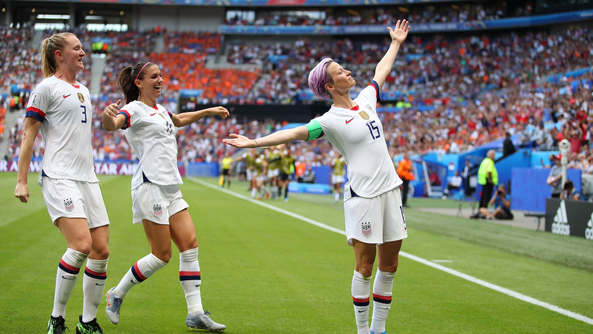 Megan Rapinoe of the USA celebrates with teammates Alex Morgan and Samantha Mewis after scoring during the 2019 FIFA Women's World Cup France Final match.