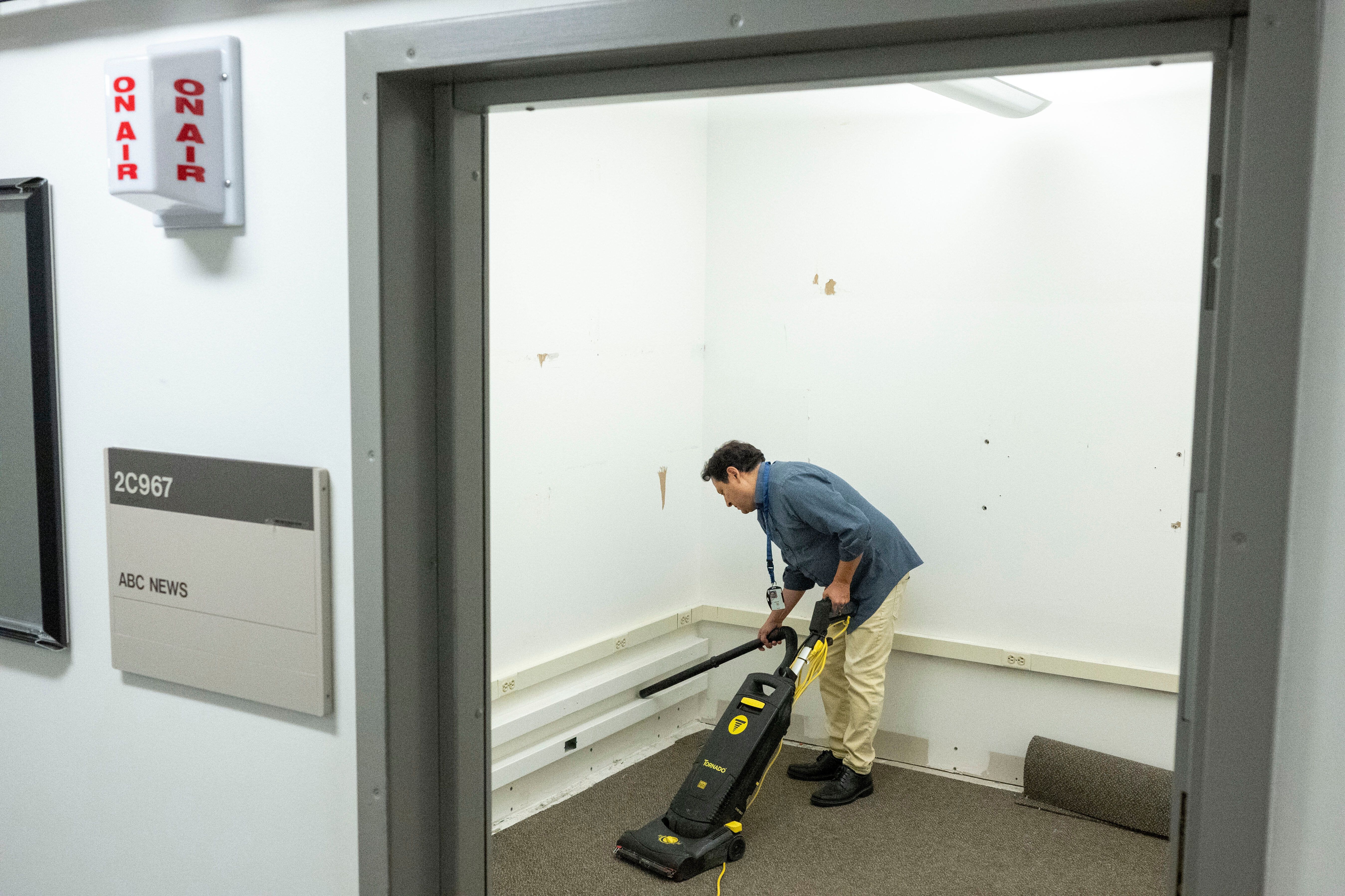 Luis Martinez with ABC News cleans the network's broadcast booth in the press area of the Pentagon.