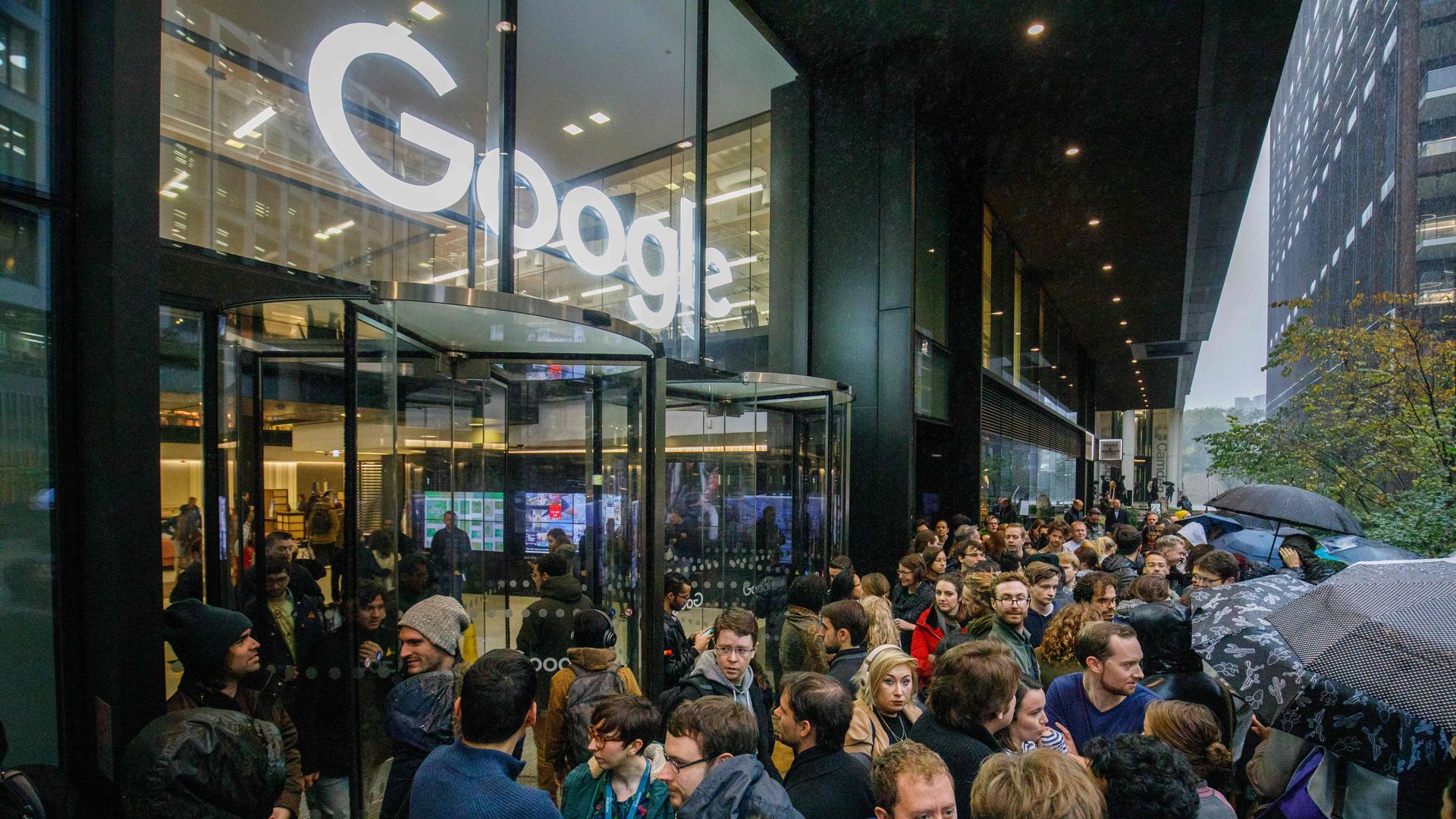 Google employees walkout with Google logo shown.