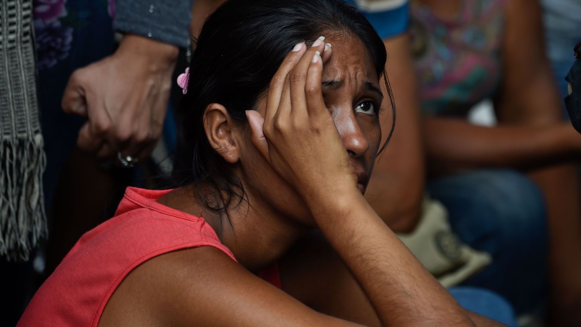 Relatives of prisoners wait outside the police headquarters in Valencia, northern Carabobo state, Venezuela