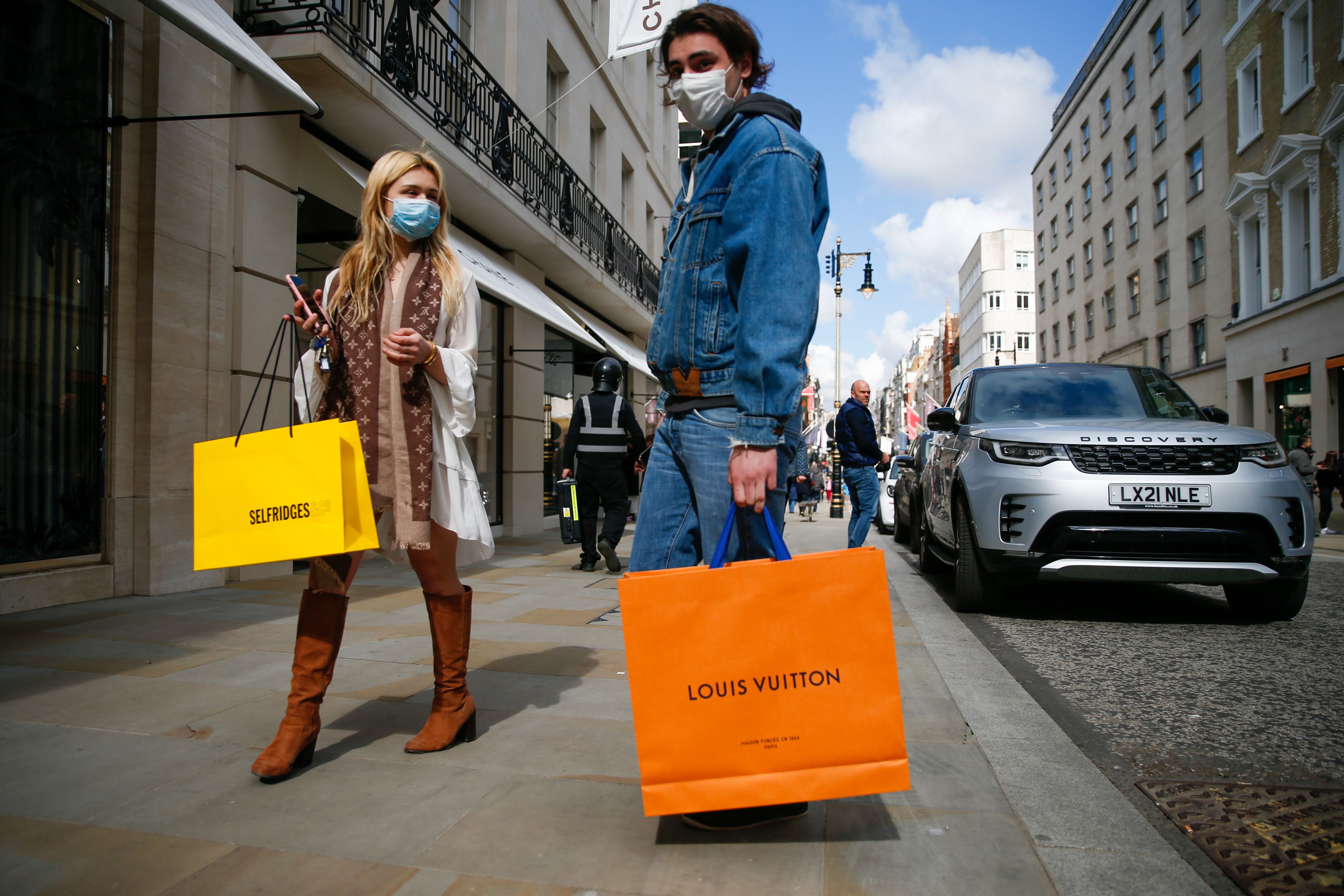 A shopper carries a Louis Vuitton shopping bag on London's Oxford