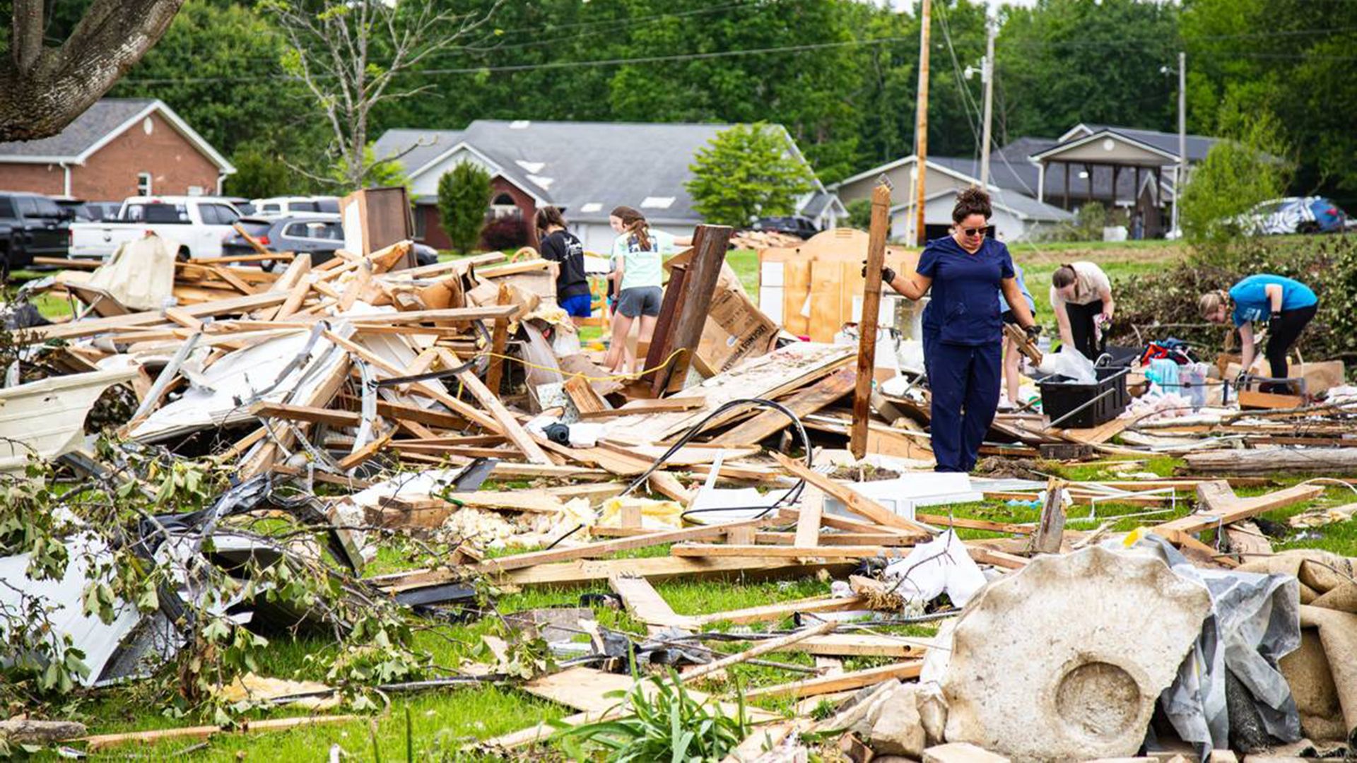 Members of the community and from surrounding areas assist with clean-up efforts in the Sunshine Hills subdivision following Saturday's deadly tornado storm in Laurel County on May 17, 2025, in London, Kentucky.