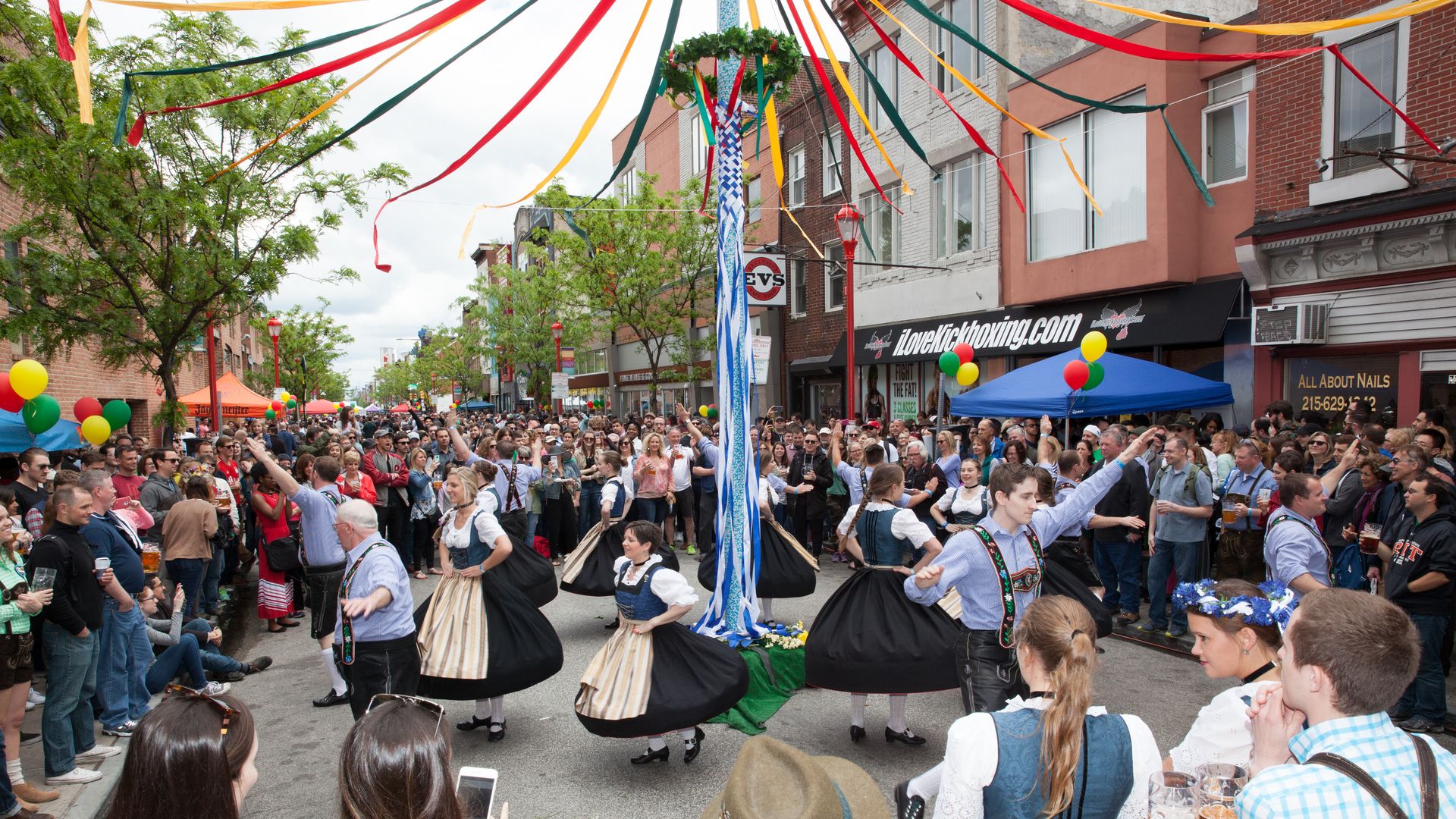 People dancing around a May pole