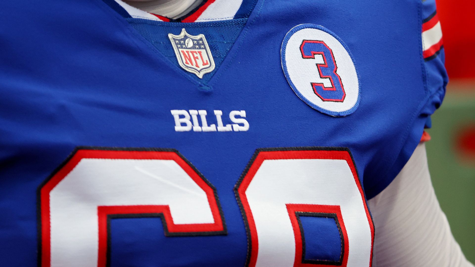 Football jersey closeup with patch of number three.