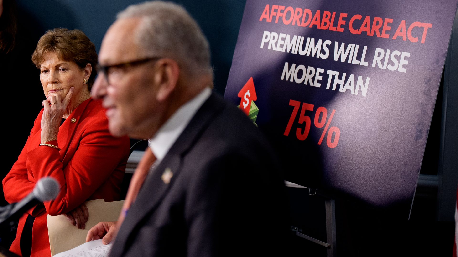 A poster reads "Affordable Care Act Premiums Will Rise More Than 75%" as Senate Minority Leader Chuck Schumer (D-NY) (2nd-L), accompanied by Sen. Jeanne Shaheen (D-NH) (L), speaks at a news conference to call on Republicans to pass Affordable Care Act tax breaks on Capitol Hill.