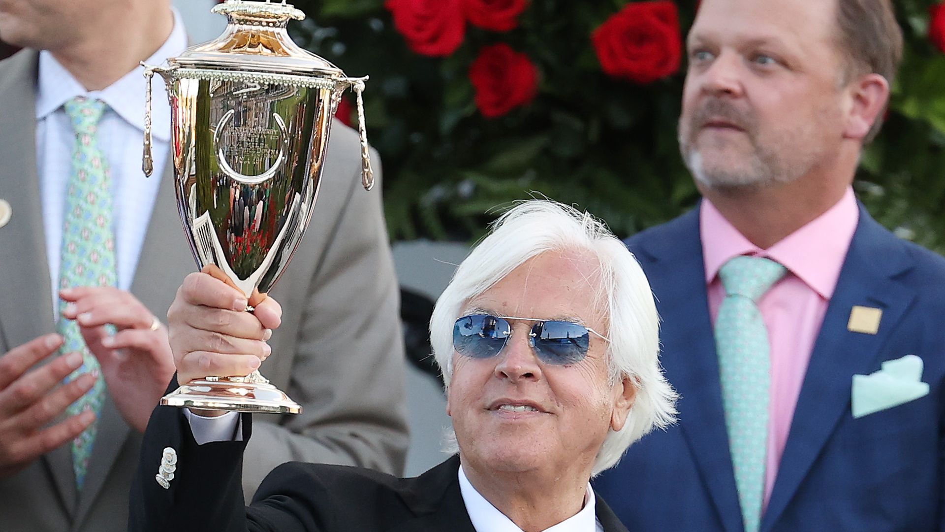 Bob Baffert holding the Kentucky Derby trophy