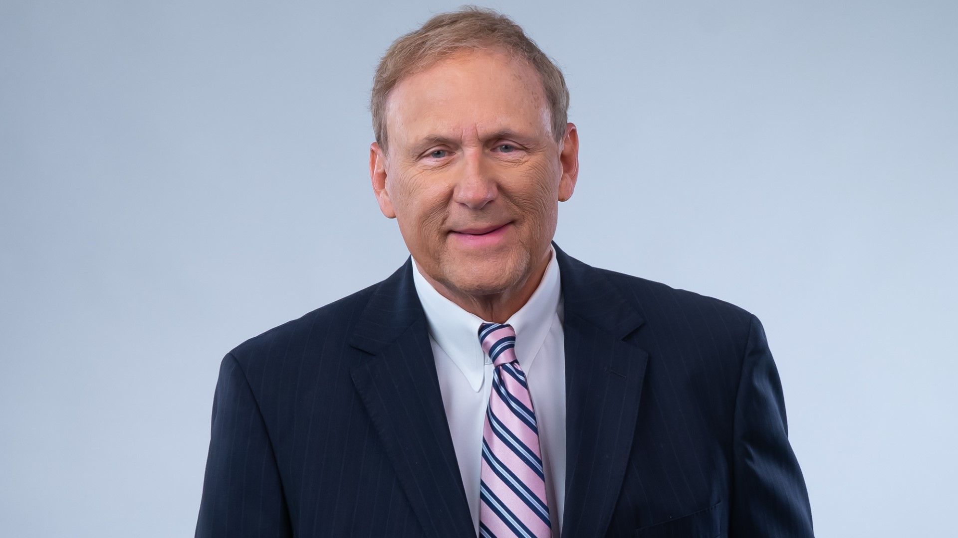 Photo shows Eric Paulsen in a suit and tie.