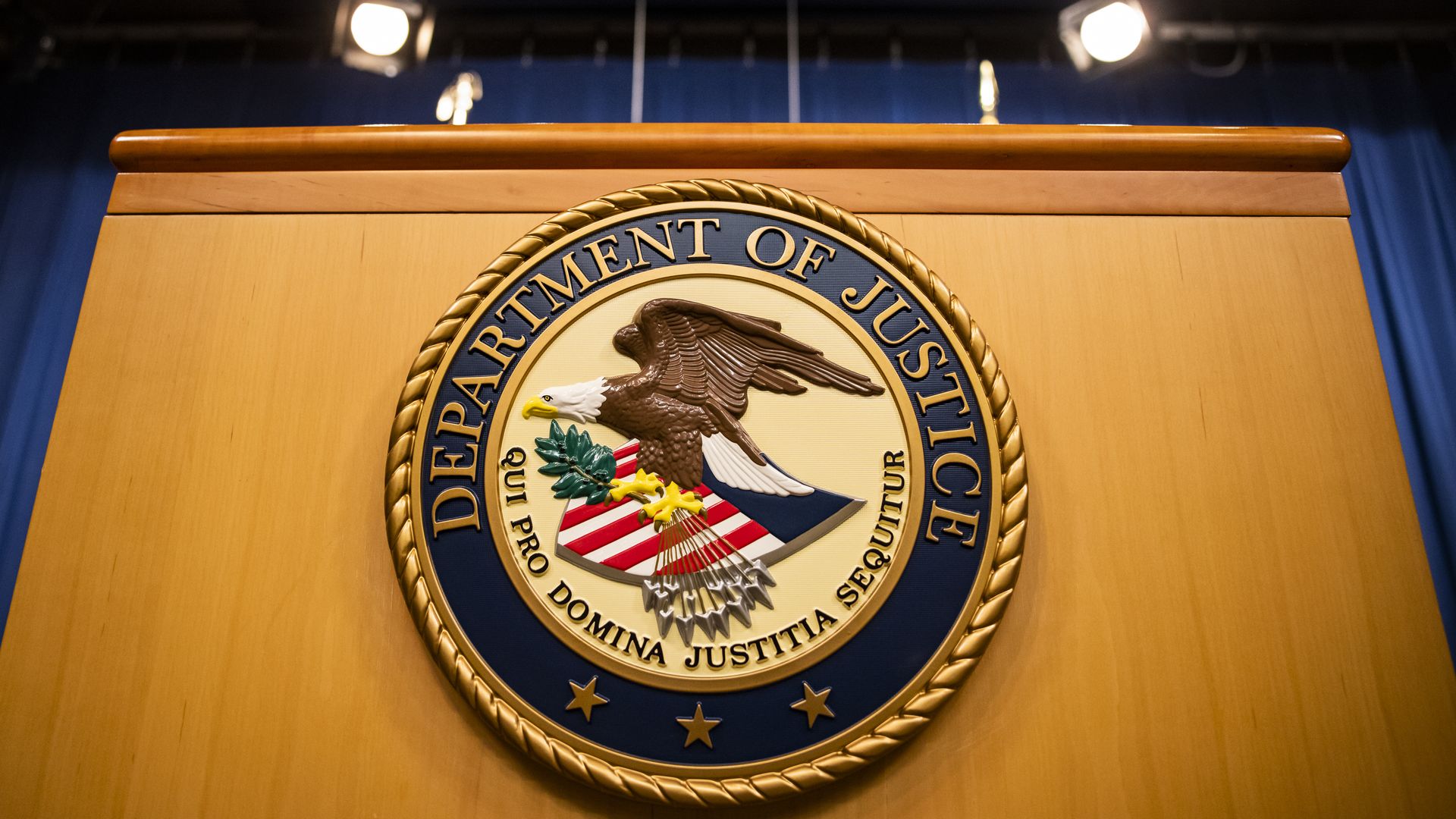 The U.S. Department of Justice seal on a podium in Washington, D.C., U.S., on Thursday, Aug. 5, 2021. 