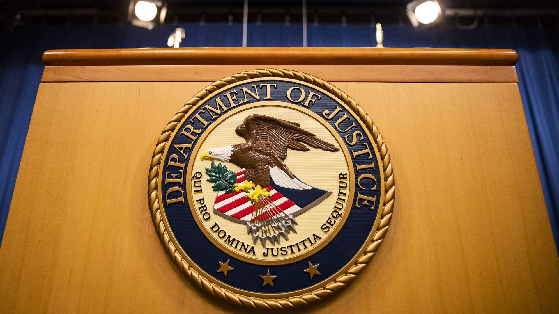 The U.S. Department of Justice seal on a podium in Washington, D.C., U.S., on Thursday, Aug. 5, 2021.