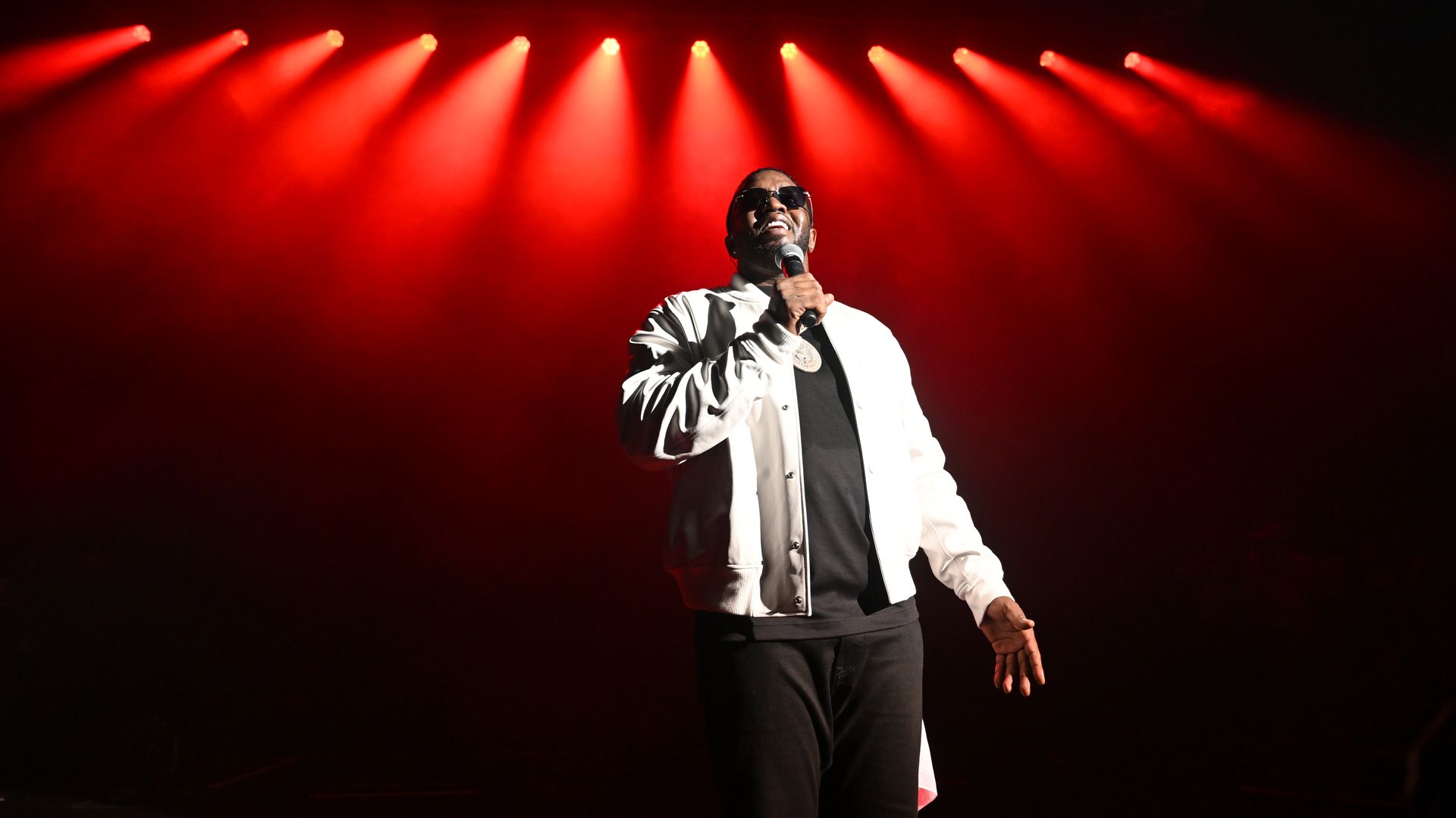 Sean "Diddy" Combs performs with a microphone in hand.