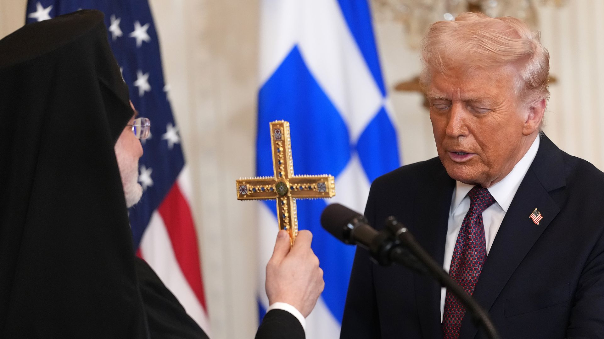 rchbishop Elpidophoros of the Greek Orthodox Archdiocese of America gives U.S. President Donald Trump a holy cross during a Greek Independence Day celebration at the White House on March 24, 2025.