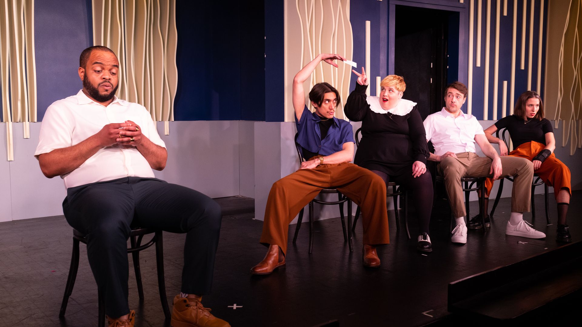 Photo of actors on stage doing a play.