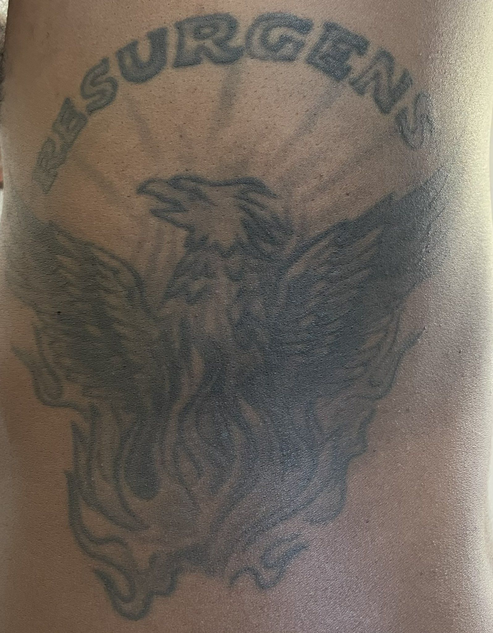 A tattoo of the Atlanta logo featuring a phoenix and the word Resurgens