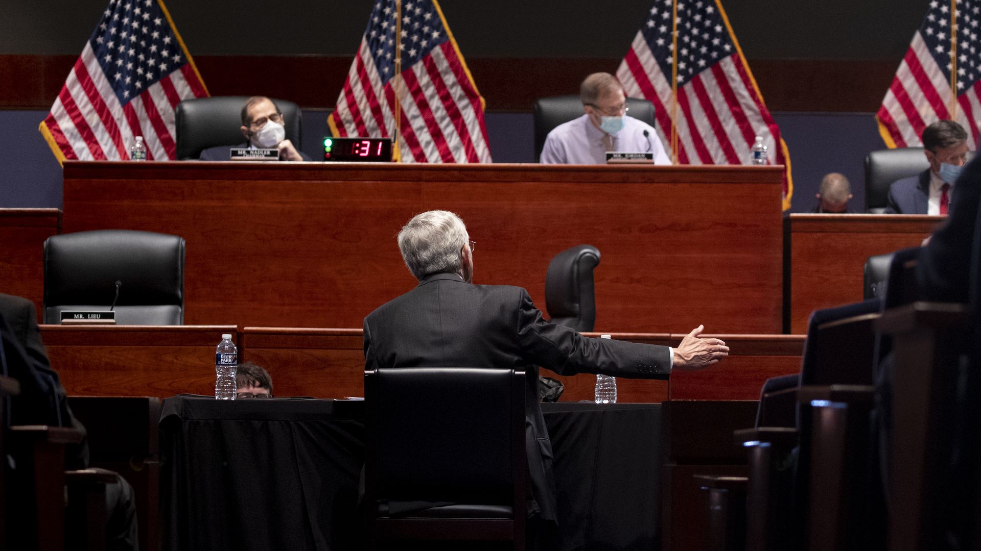 Attorney General Merrick Garland is seen from behind as he testifies before the House Judiciary Committee.