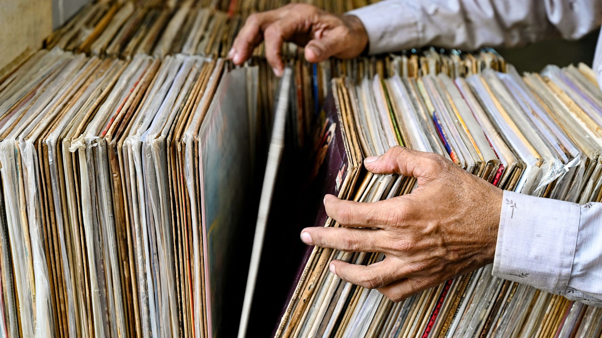 A shopper flips through vinyl records