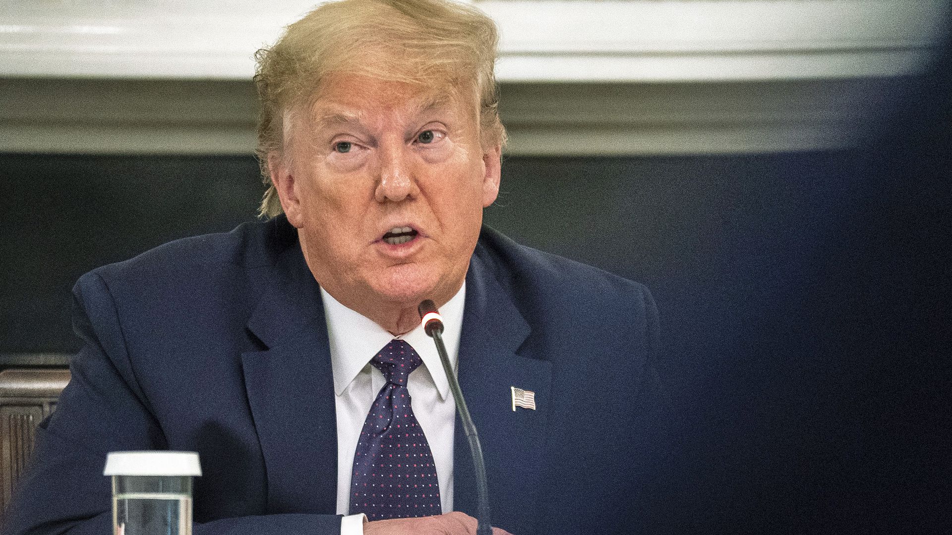 President trump sitting at a table