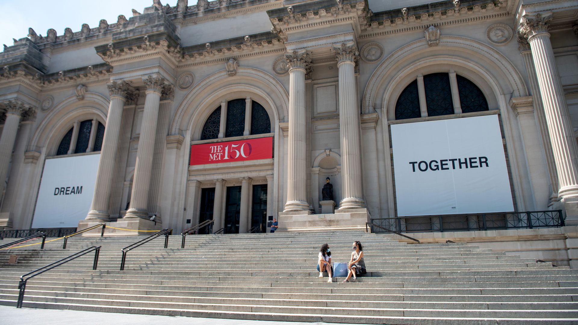 People weairng masks sit on the stairs at The Metropolitan Museum of Art on August 23, 2020 in New York City. 