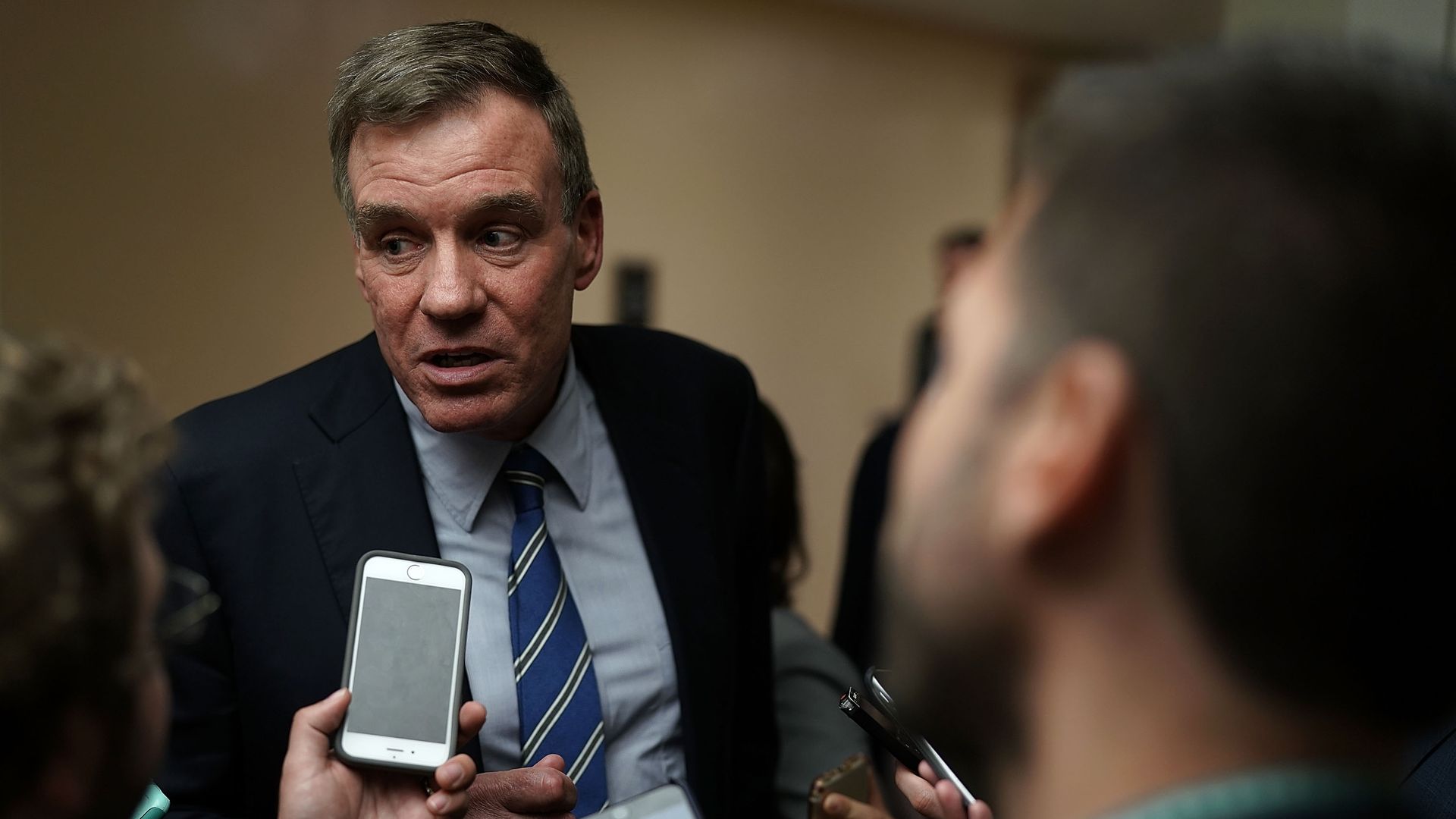 Mark Warner talks to reporters