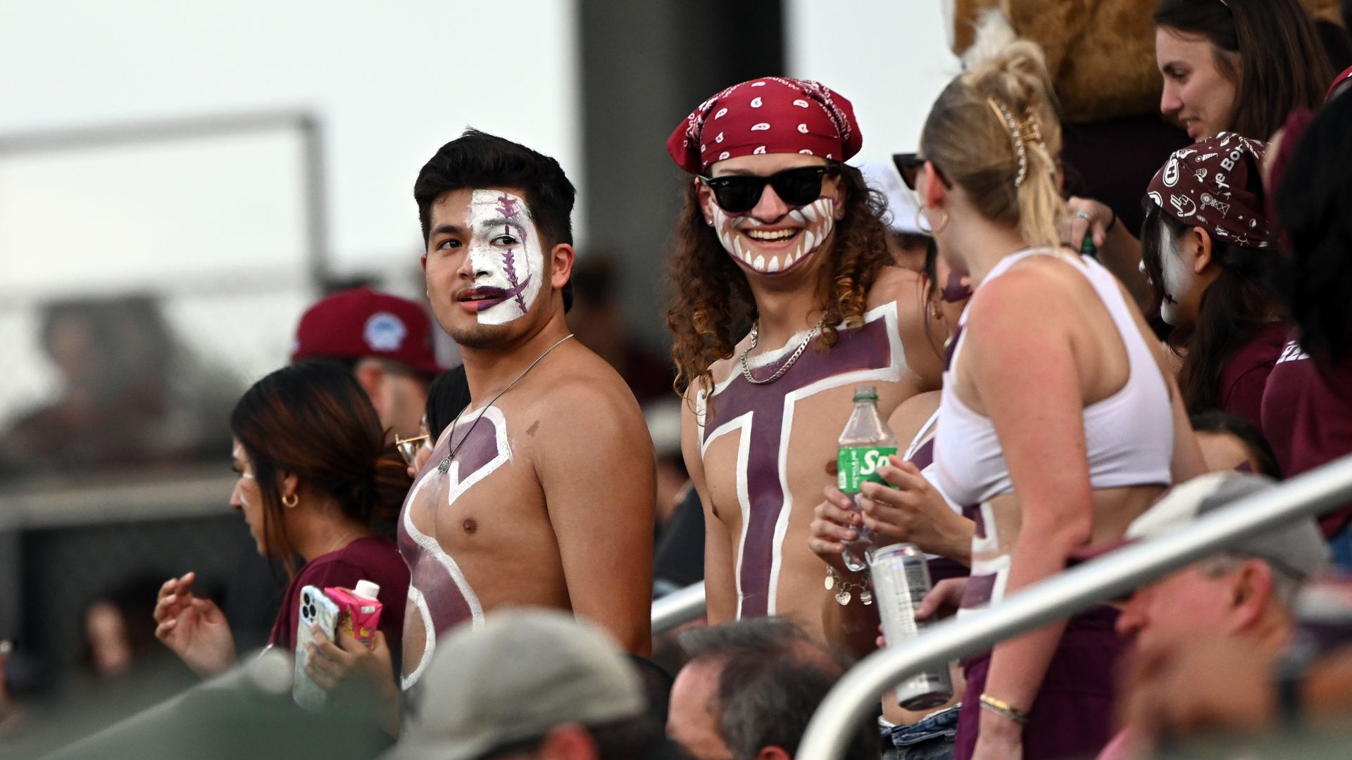 Texas State fans, shirtless, with the letters "S" and "T" painted on their bodies.
