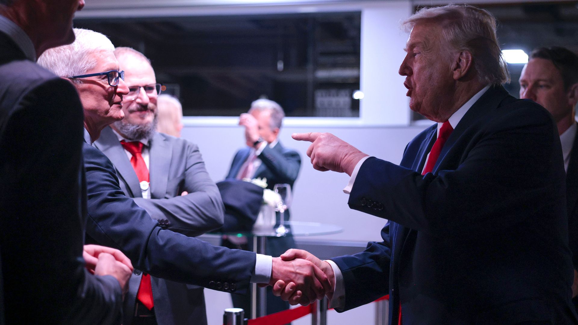 President Donald Trump (R) speaks to Apple CEO Tim Cook (L) as he attends a reception for business leaders at the World Economic Forum (WEF) Annual Meeting on January 21, 2026 in Davos, Switzerland.