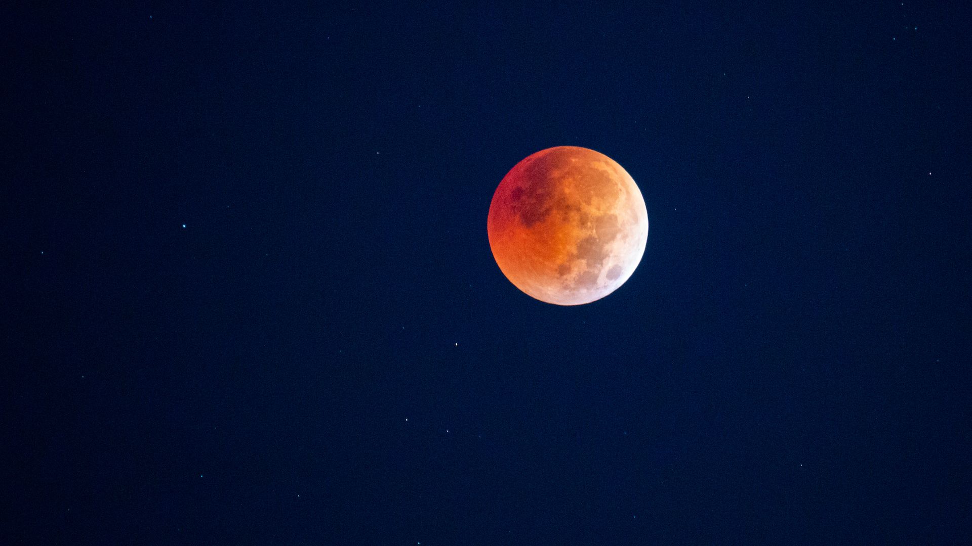 A red-hued Moon in the sky over the US during a total lunar eclipse