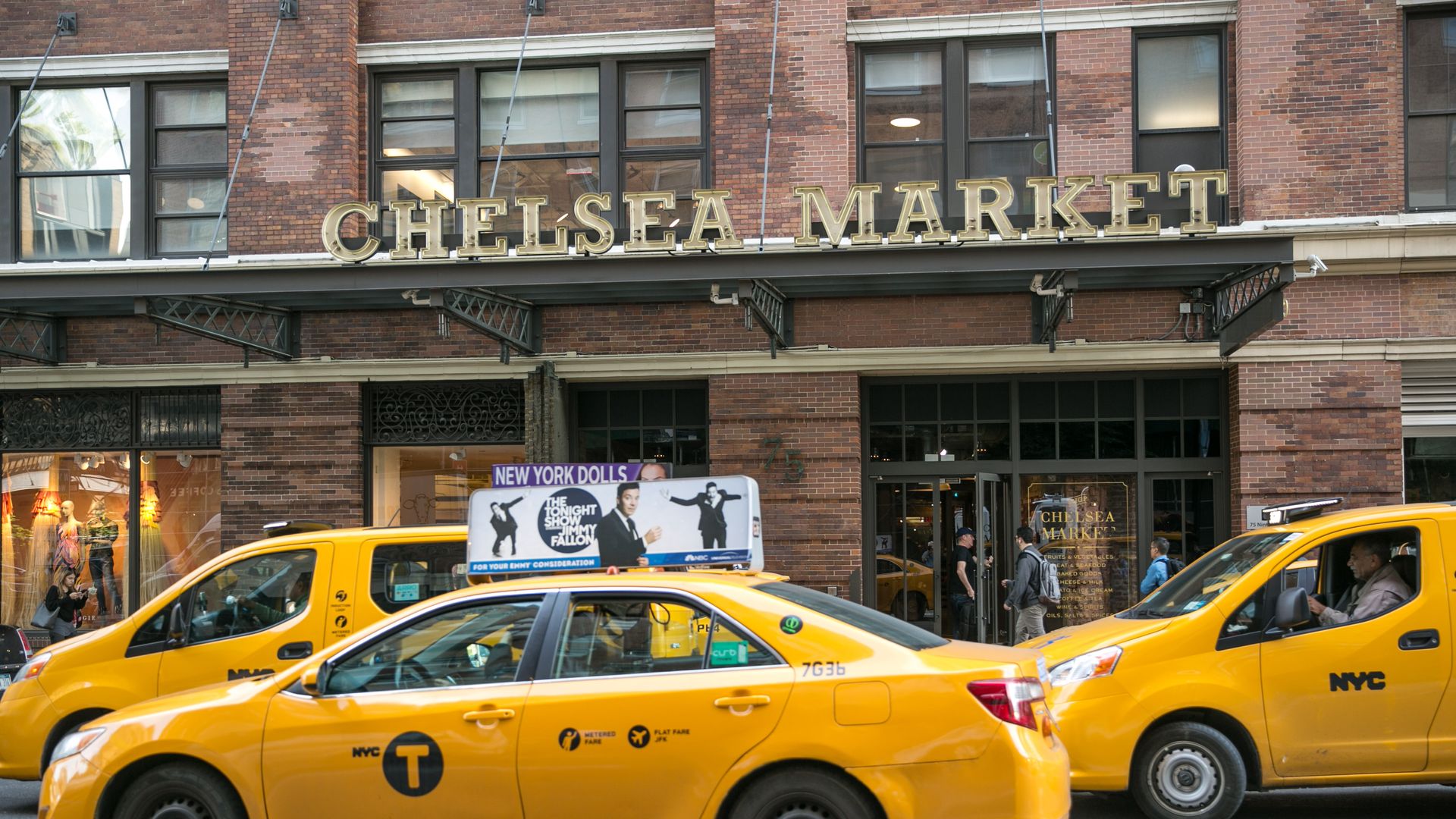 Yellow cabs in front of the entrance to the Chelsea Market building