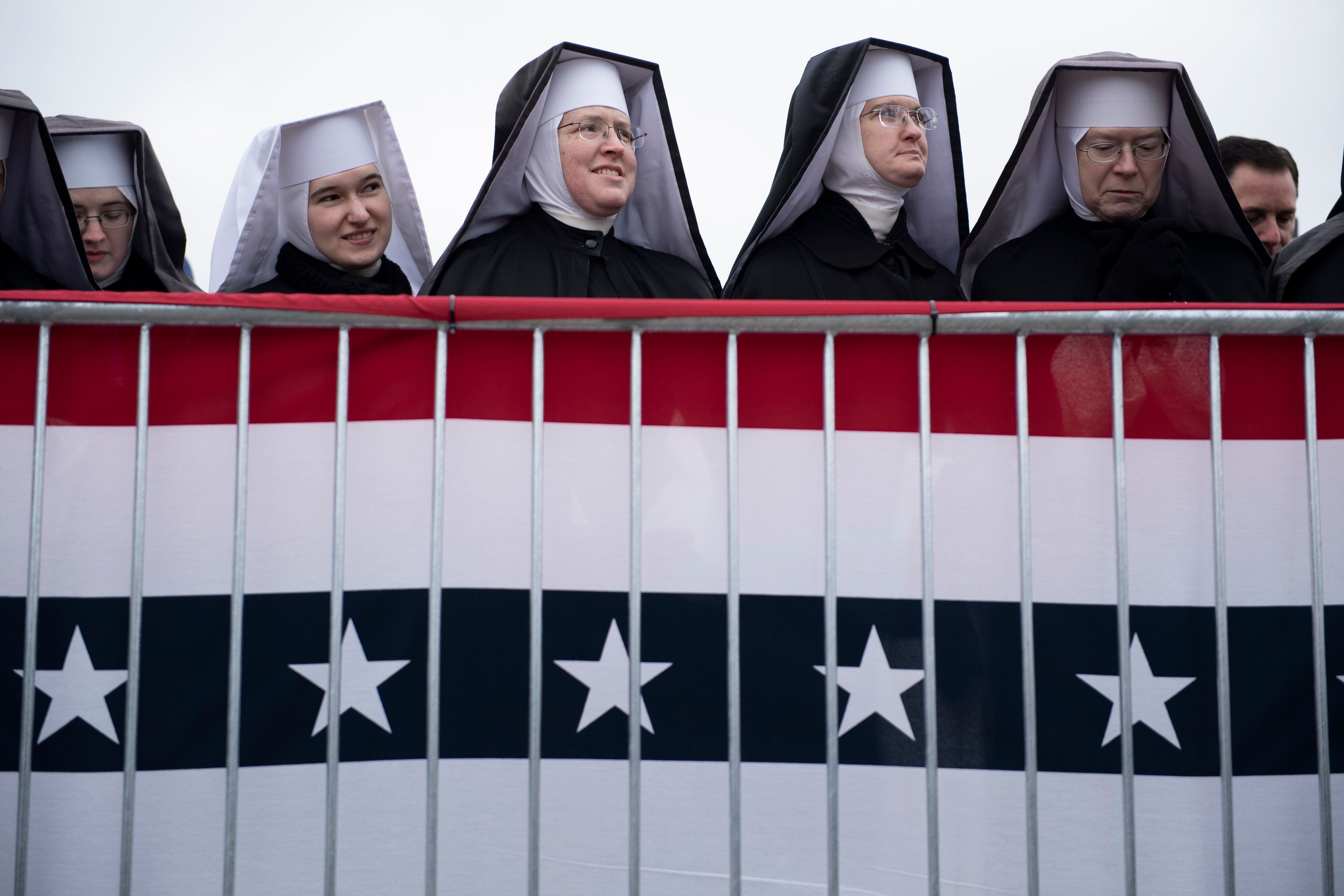  Little Sisters of the Poor wait for US President Donald Trump to speak during a "Make America Great Again" rally at Total Sports Park on November 1, 2020, in Washington, Michigan.
