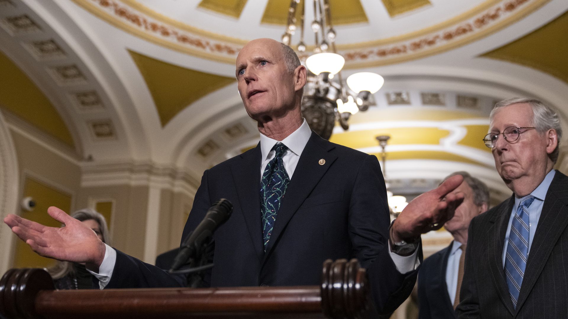  Sen. Rick Scott (R-FL) speaks to reporters as Senate Minority Leader Mitch McConnell (R-KY) looks on after meeting with Senate Republicans at the U.S. Capitol November 29, 2022 