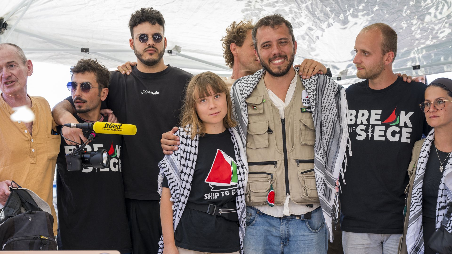 Greta Thunberg stands with other activists 