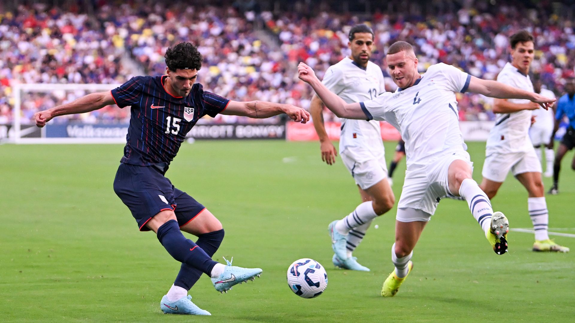 A U.S. Men's soccer player strikes the ball.