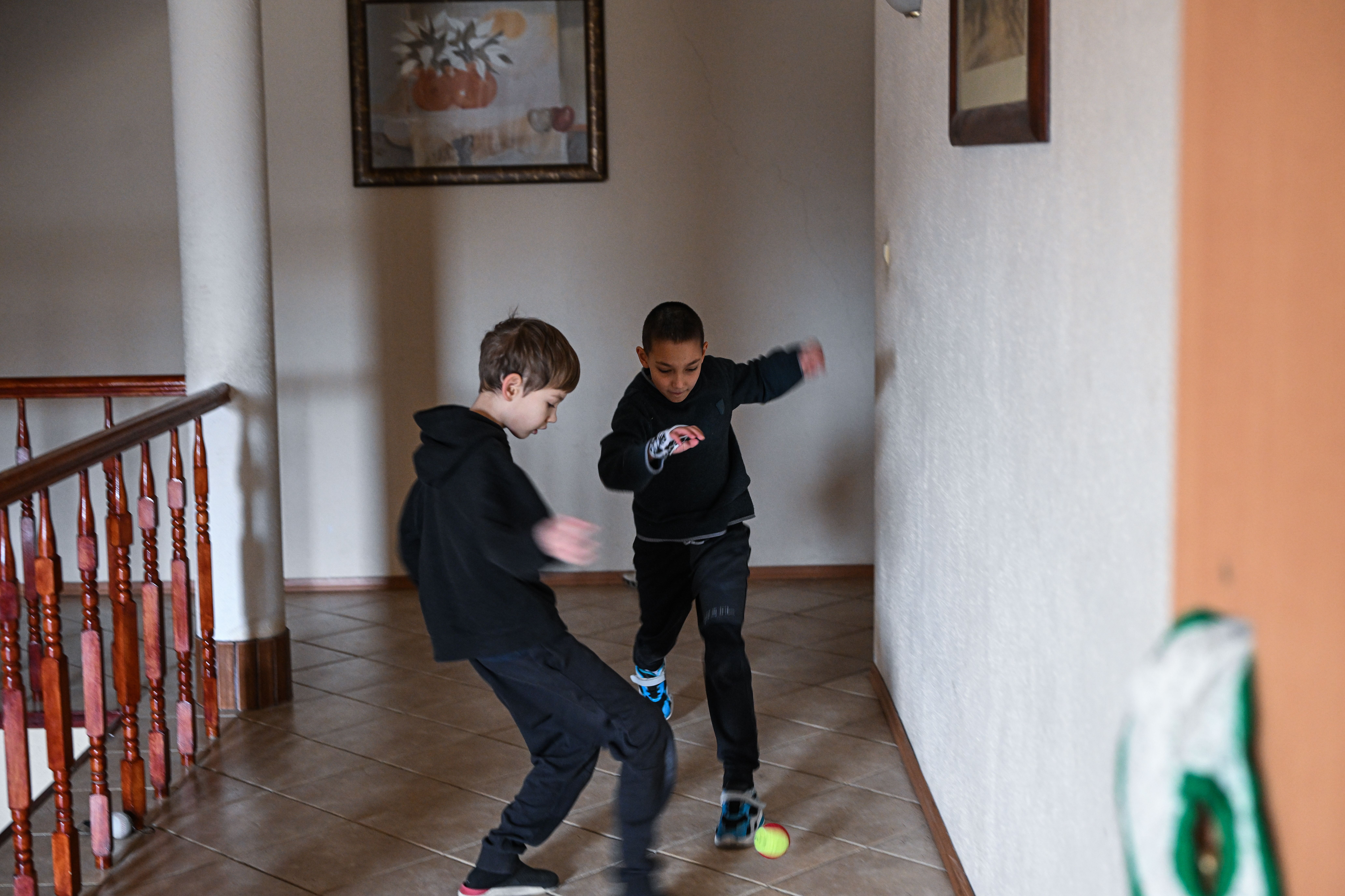 Children who fled the war in Ukraine with their mothers play with a ball on the corridors of the Green Hotel on February 23, 2023 in Jerzmanowice, Poland