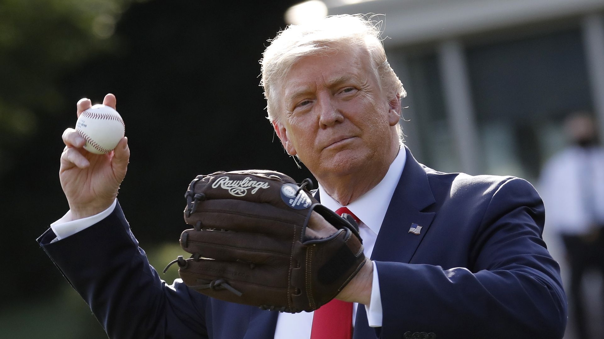 Picture of Trump wearing a baseball glove and about to throw a baseball
