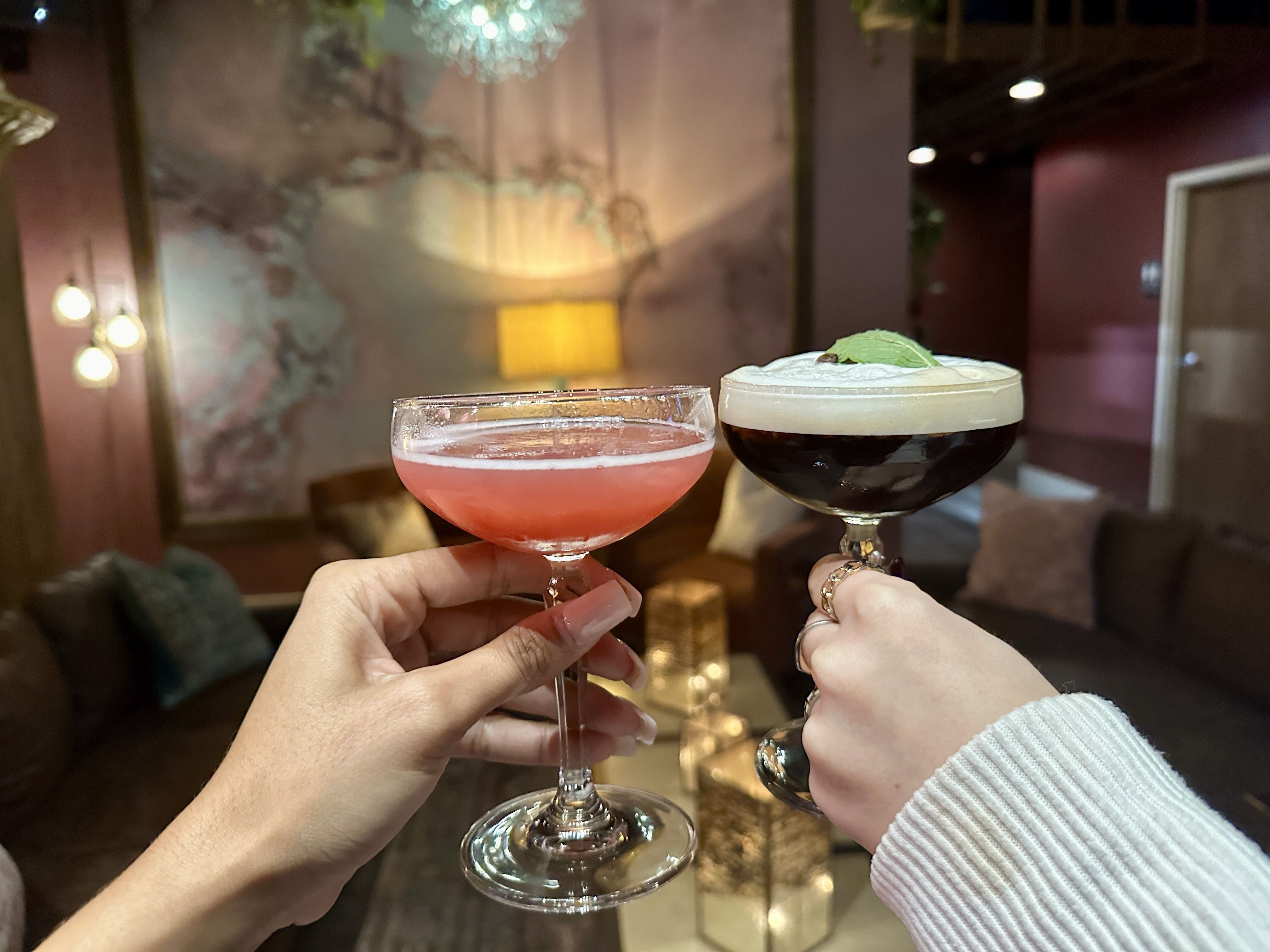 two hands holding drinks to do a cheers