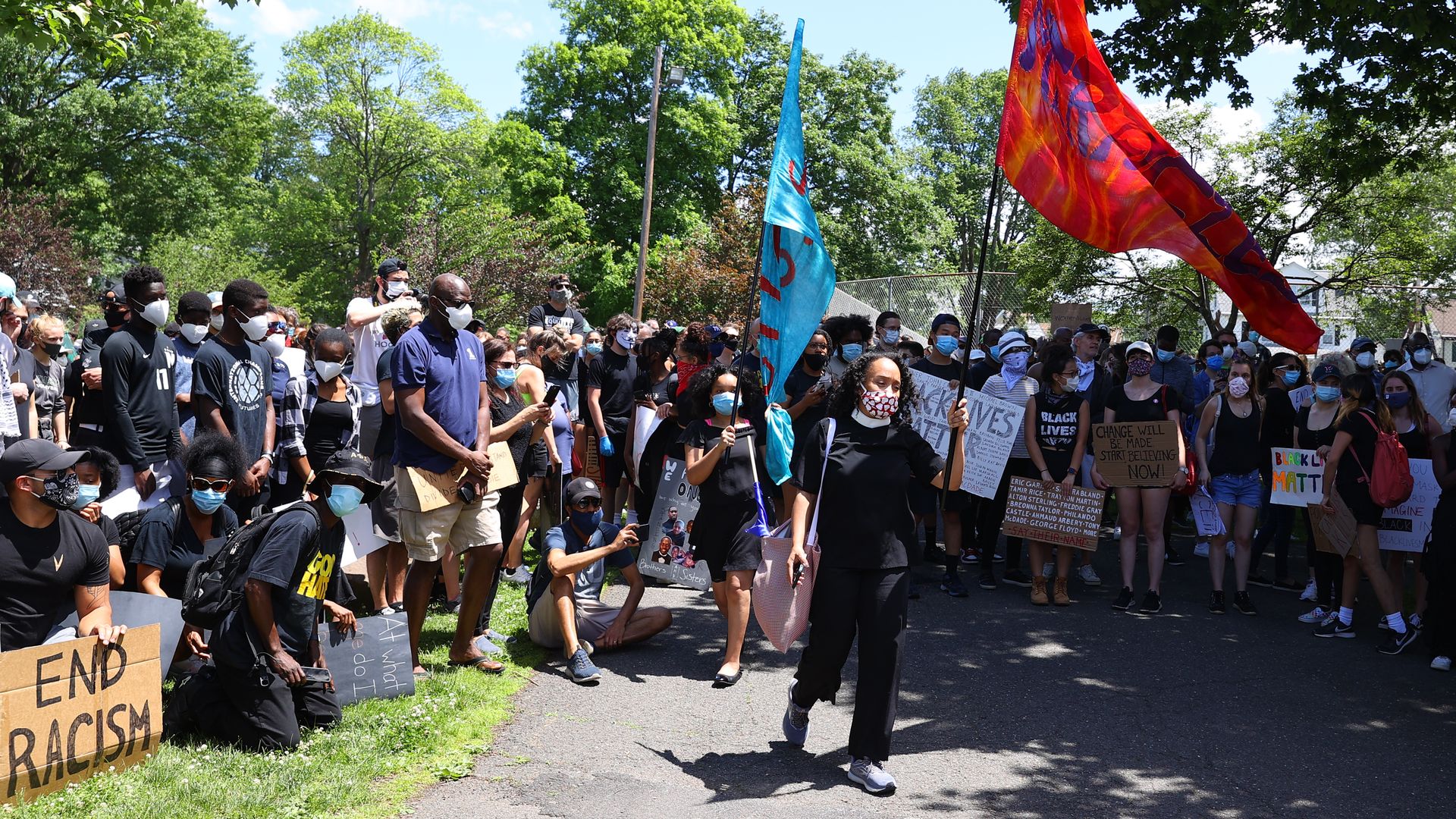  A peaceful group of very diverse protesters hold up signs during a Black Lives Matter protest on June 07, 2020, at Taylor Park Millburn, NJ