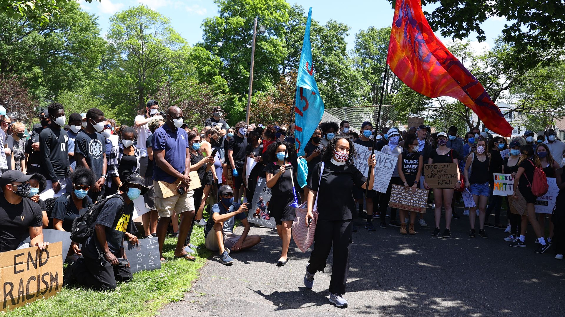 A peaceful group of very diverse protesters hold up signs during a Black Lives Matter protest on June 07, 2020, at Taylor Park Millburn, NJ