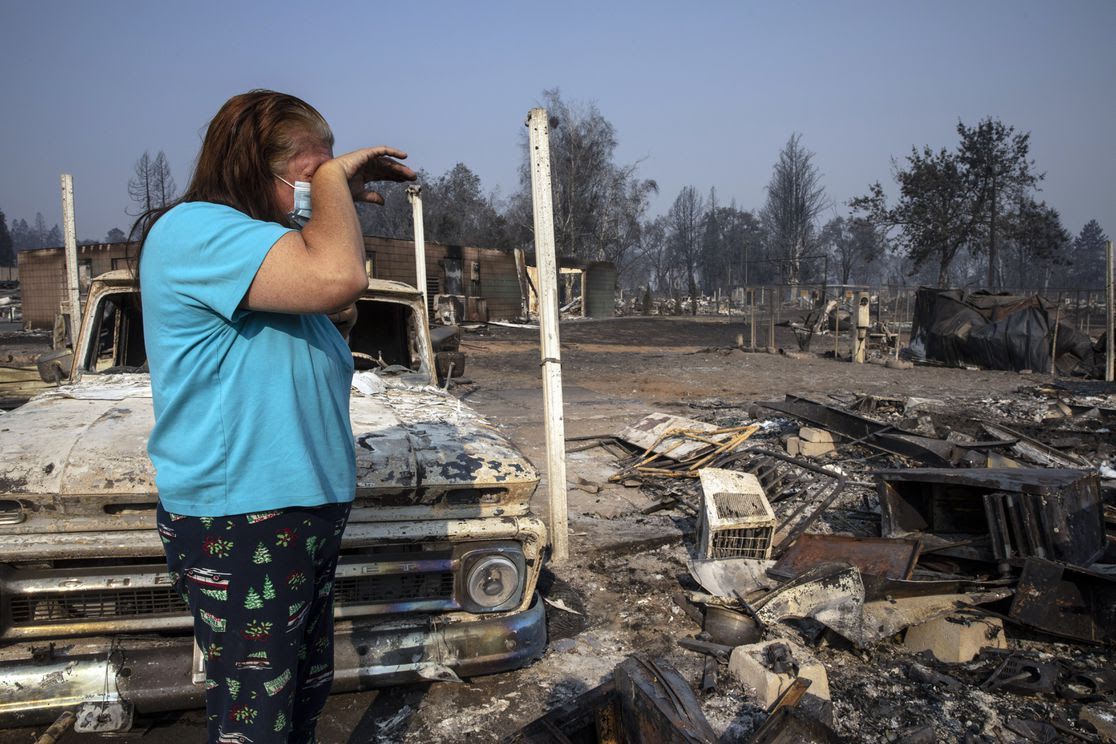 Heather Marshall stands by the destruction of her home at Coleman Creek Estates mobile home park in Phoenix, Ore., yesterday. Photo: Paula Bronstein