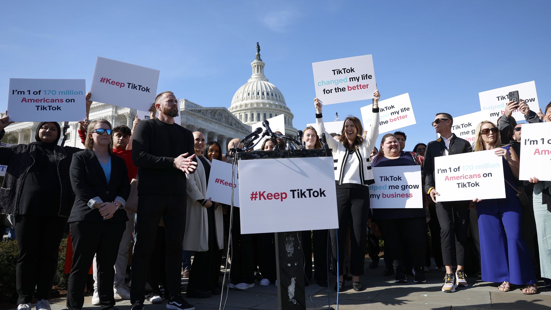 Protestors in front of the Capitol hold signs that say #KeepTikTok and "TikTok changed my life for the better"