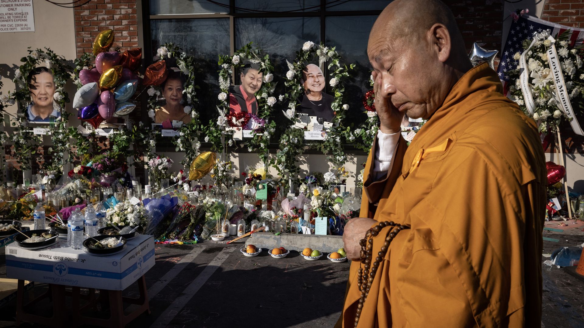 A Buddhist Monk prays and pays respect at a vigil outside the Star Dance Studio, the sight of a mass shooting where 11 people were killed and 9 others wounded, in Monterey Park, California.