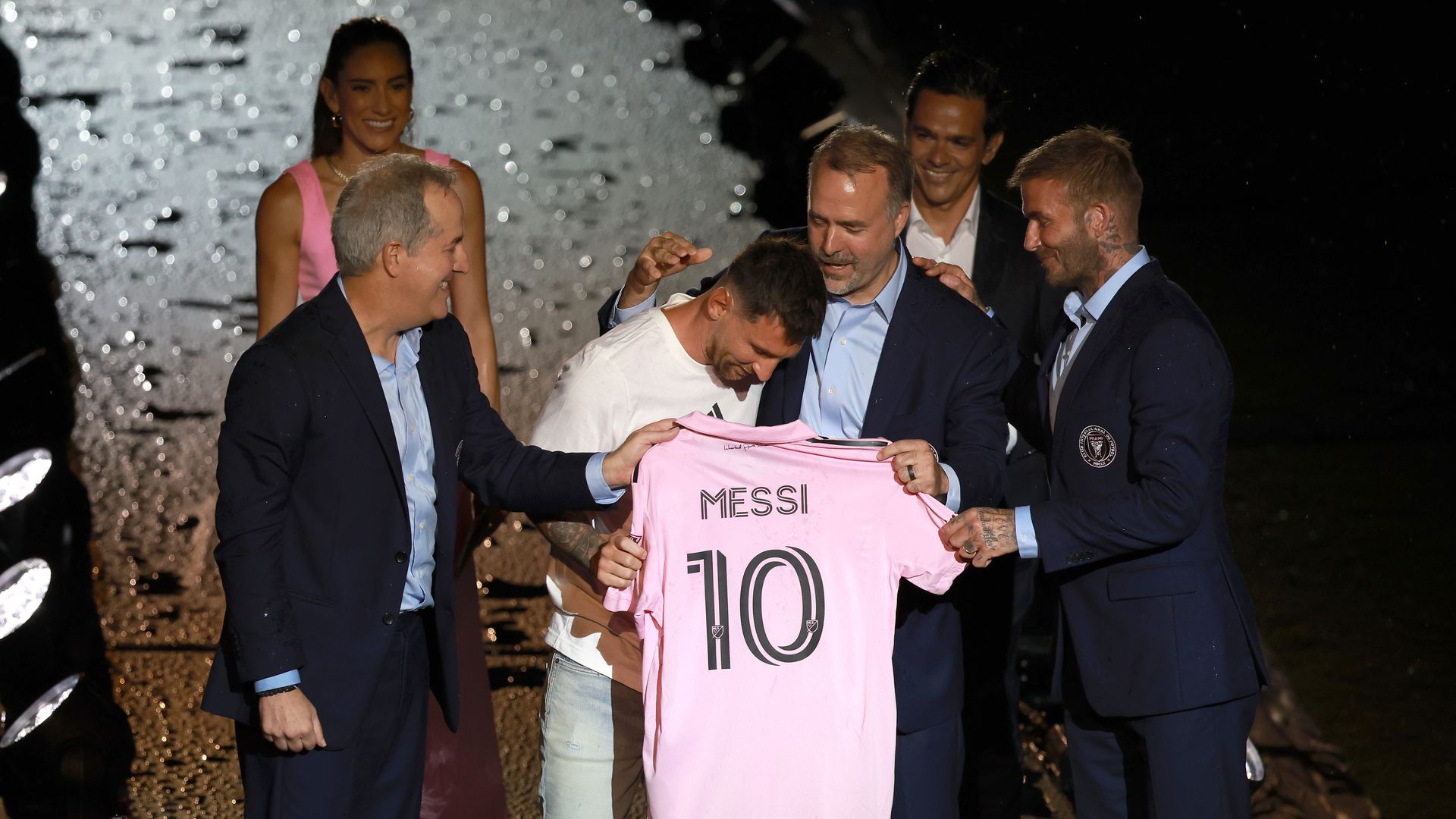 Lionel Messi is presented his new Inter Miami jersey by the team's owners at a welcome party.
