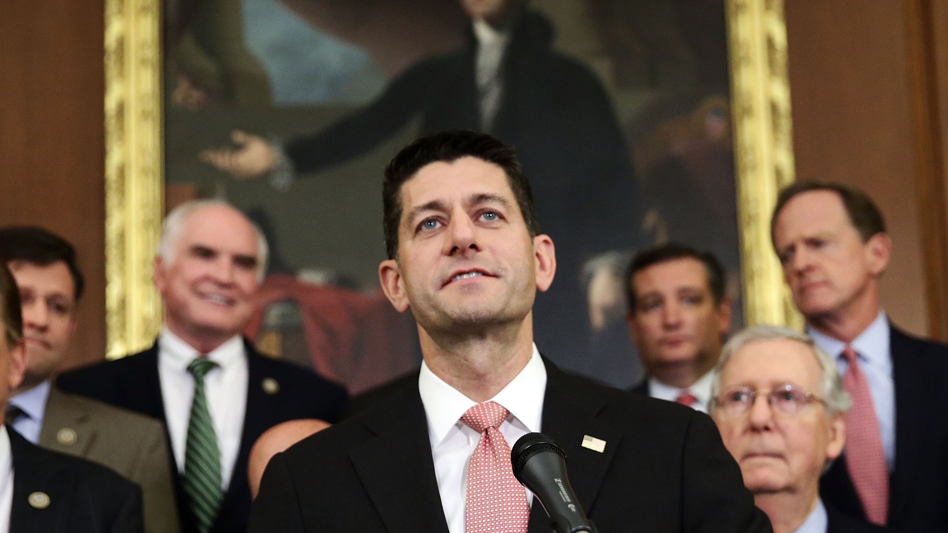 Paul Ryan smiles while standing in front of other leaders of the GOP
